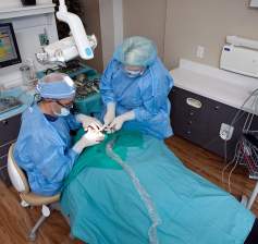 Ramsey Amin performing sterile dental implant surgery