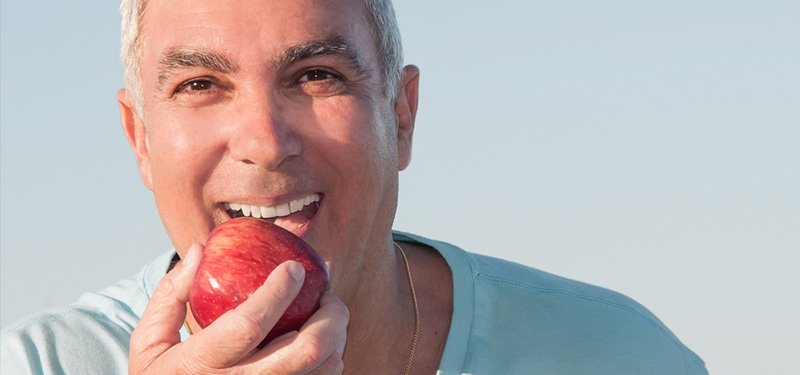 man eating apple